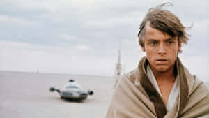 Luke Skywalker在沙漠中，身後有一輛飛梭摩托車 — 星際大戰 壁紙