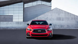 紅色Infiniti汽車停放在現代混凝土和玻璃建築前。 — 酷車 壁紙