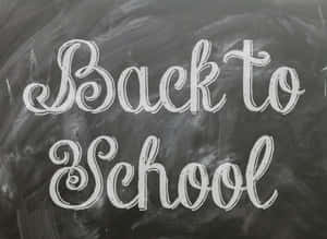 黑板上用白色草書寫著「Back to School」。