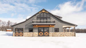 冬季田野中的現代穀倉，石頭地基，屋頂積雪。