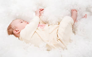 一個睡在蓬鬆白色雲朵床上的嬰兒