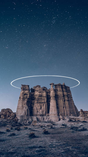 沙漠岩石地貌，星空下帶有發光光暈。
