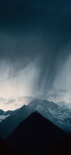 暴風雨天空下，大雨中的黑暗山峰。
