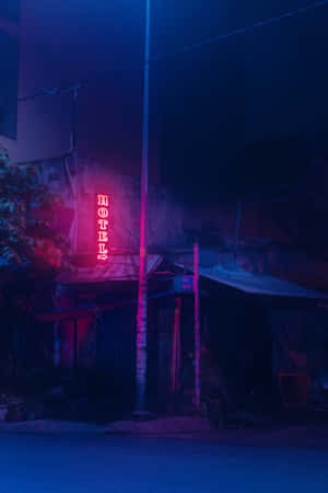 霓虹燈酒店招牌在夜晚用粉紅色和藍色光芒照亮黑暗的城市小巷。 — 形容詞 GIF 壁紙