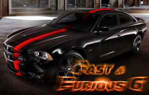 黑色Dodge Charger在黑暗倉庫中帶有紅色條紋，Fast & Furious 6標誌。