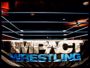 摔角擂台，在明亮聚光燈下帶有 Impact Wrestling 橫幅。 — 摔角 GIF 壁紙