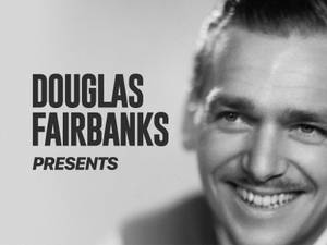 道格拉斯·費爾班克斯微笑，旁邊有文字「DOUGLAS FAIRBANKS PRESENTS」。 — 黑白 壁紙