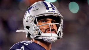 夜間比賽中戴頭盔的達拉斯牛仔隊美式足球員。 — NFL 美式足球 GIF 壁紙
