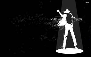 聚光燈下米高積遜的剪影，附有「King of Pop」文字。