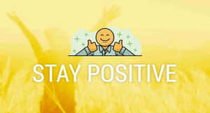 一個微笑嘅卡通人物豎起兩個大拇指，上面有STAY POSITIVE字樣，背景係金色麥田。