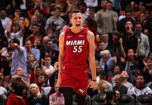 邁阿密熱火55號球員在歡呼的球迷面前慶祝勝利。