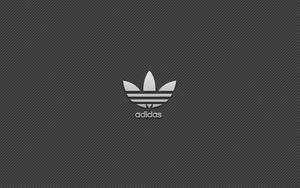 深灰色斜紋背景上的Adidas標誌