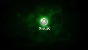 Xbox標誌在黑暗空間中發出綠色光芒，伴有粒子 — Xbox GIF 壁紙