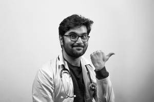 一位微笑的醫生穿著白袍做出豎起大拇指的手勢。 — 異世奇人 GIF 壁紙