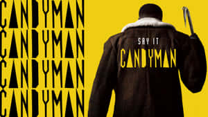一個穿著外套的男人背面，手持鉤子，背後和背景有「CANDYMAN」文字。 — iMac 壁紙
