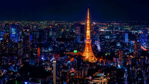 東京塔在夜晚亮起，周圍環繞著發光的城市燈光。 — 日本 壁紙