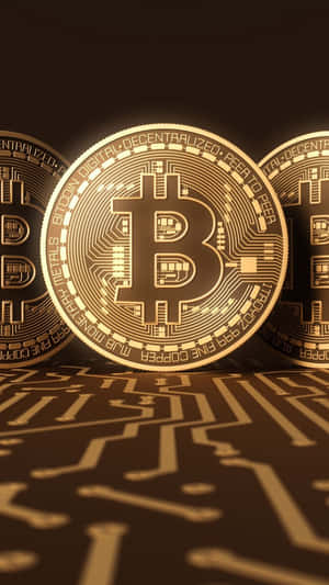 三枚發光的金色比特幣硬幣放置在電路板表面上。 — 加密貨幣 壁紙