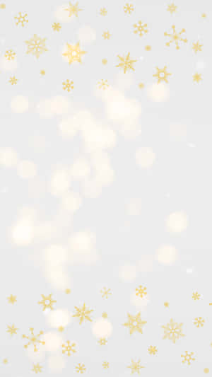 金色雪花在背景中伴隨柔和發光燈光飄落。 — 溫馨聖誕美學 壁紙