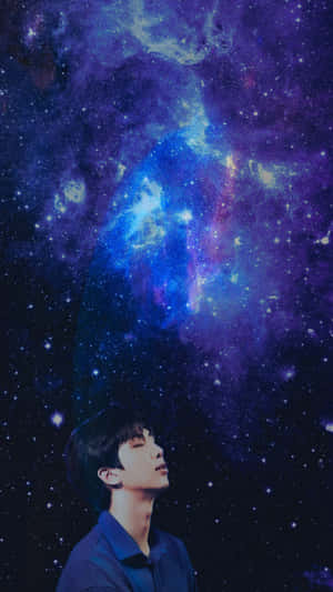 年輕人仰望帶有星雲的多彩星空。