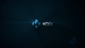 Kodi 媒體播放器標誌，在黑暗背景上帶有藍色光芒和鏡頭光暈。
