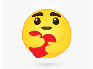 黃色表情符號帶著開心表情拿著紅色心臟。