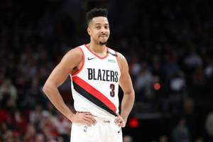 身穿 Blazers 隊服的職業籃球運動員在球場上雙手叉腰站立。 — 機關槍凱利 壁紙
