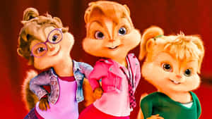三個花栗鼠女孩穿著時尚服裝，對著鏡頭溫暖地微笑。 — 阿爾文與_chipmunks 壁紙