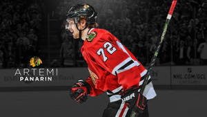 冰球運動員 Artemi Panarin 身穿紅色黑鷹隊球衣在冰上慶祝。