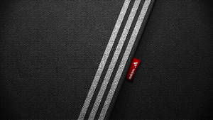 帶有白色adidas條紋和紅色品牌標籤的黑色布料。