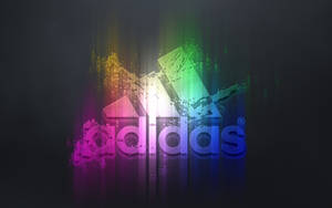 深色背景上帶有彩色發光粒子的 Adidas 標誌