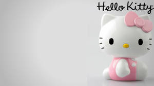 Hello Kitty公仔，帶有粉紅色蝴蝶結和連衣裙，在純灰色背景上