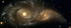 兩個螺旋星系在深空中與明亮的恆星碰撞。