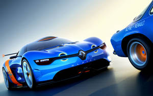 兩輛藍色 Alpine-Renault 賽車，帶有橙色點綴，在反光賽道上。