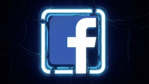 黑暗中發光的霓虹燈Facebook標誌，電線可見。