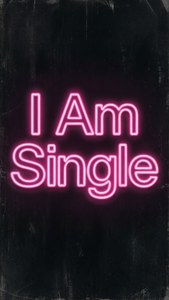 粉紅色霓虹燈牌在紋理深色牆上寫著 I Am Single。