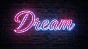 夜間磚牆上寫有「Dream」的霓虹燈牌。 — AMOLED 壁紙