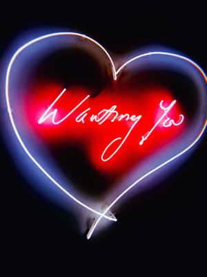 霓虹心形標誌，顯示 'Wanting You'，以紅色和白色發光。