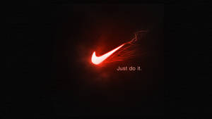 紅色Nike剔號標誌，帶有火熱軌跡和「Just do it.」文字，黑色背景 — 型格 Nike 壁紙