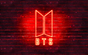 夜間磚牆上的紅色霓虹BTS標誌。