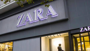 夜晚的Zara服裝店，帶有發光標誌和玻璃窗。 — 淺紫色動態圖片 壁紙