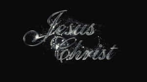 閃亮嘅銀色草書文字 Jesus Christ 帶有閃爍粒子喺黑色背景上