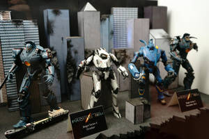 四個 Pacific Rim Jaeger 動作人偶在帶有標籤的城市景觀立體模型中展示。