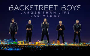 Backstreet Boys 樂隊成員在夜間拉斯維加斯城市燈光上擺姿勢。