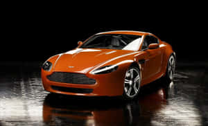 橙色Aston Martin跑車在濕滑地板上，配以攝影棚燈光。