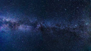 銀河系在黑暗的夜空中閃爍著紫色和藍色的星星。