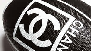 黑色足球，上面有白色 Chanel 標誌同文字。