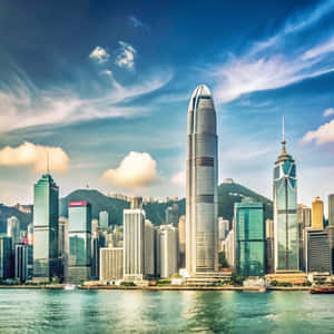 香港天際線，高樓玻璃建築，背後有山和水 — 建築 壁紙