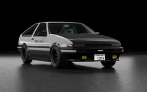 黑白豐田AE86跑車，帶有日文字和黃色頭燈，在黑暗的攝影棚中。