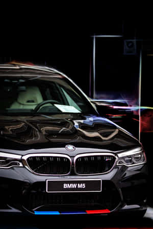 黑色BMW M5跑車，霓虹燈光在其光澤表面反射。 — 小米Pad 8 壁紙