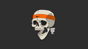 骷髏頭戴著橙色Nike頭帶，旁邊有「JUST DID IT」文字。